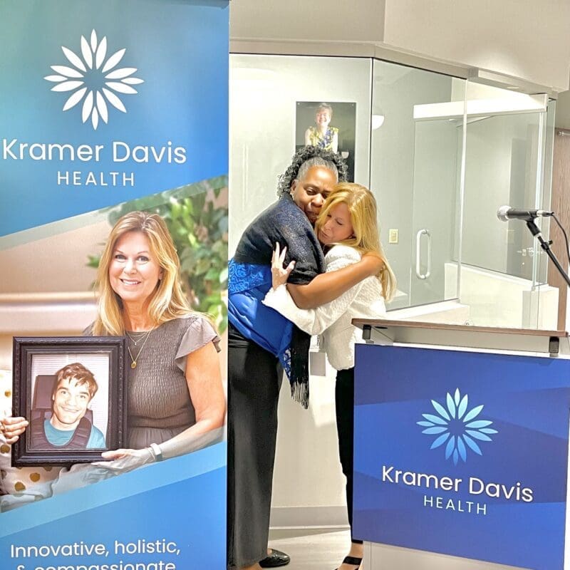 In this photo, the mothers of the two patients our clinic is named for embrace in a heartfelt hug.